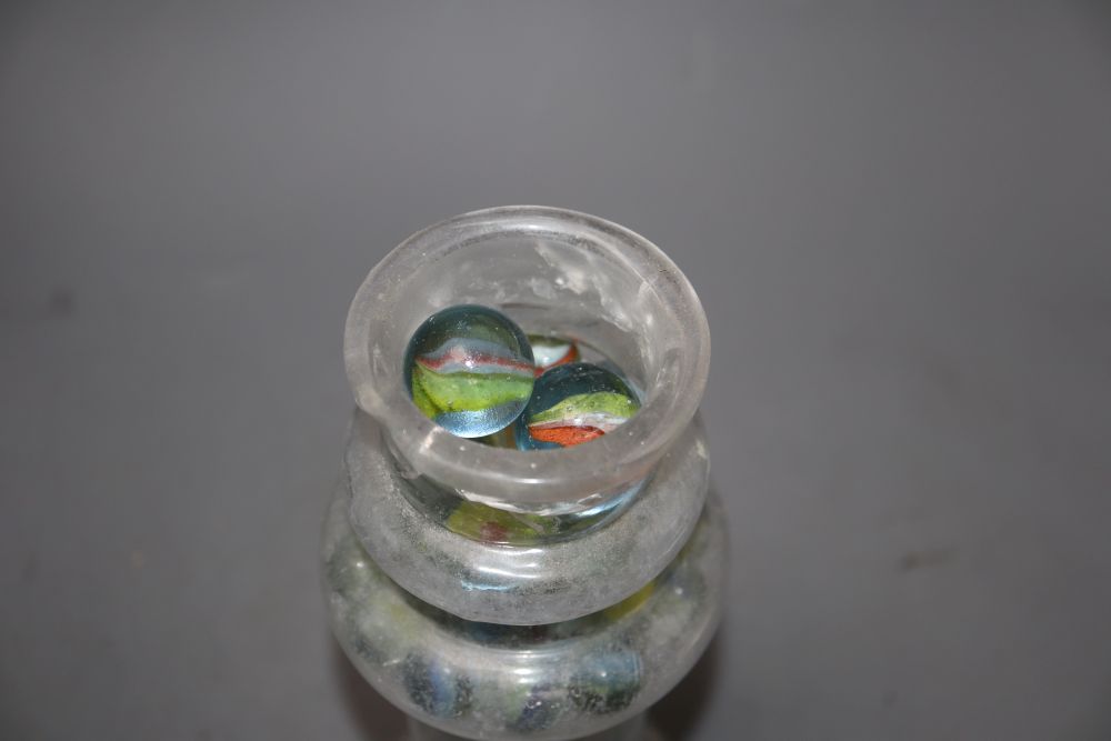 A Victorian glass vase, containing a collection of Victorian and later coloured marbles, height 27cm